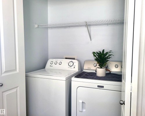 Dedicated laundry closet featuring a wire shelving unit, providing storage - 144 Kirpatrick Way, Leduc, AB - Indoor Photo Showing Laundry Room