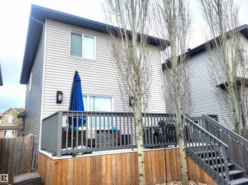 Outdoor deck featuring wood-finish railing and stairs - 144 Kirpatrick Way, Leduc, AB - Outdoor With Deck Patio Veranda With Exterior