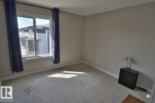 Neutral wall tones complementing light-colored carpeting - 81 446 Allard Blvd, Edmonton, AB - Indoor Photo Showing Other Room