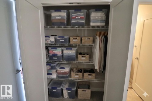Built-in closet with wire shelving system and hanging rod - 81 446 Allard Blvd, Edmonton, AB - Indoor Photo Showing Other Room
