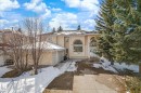 The property features an architectural style with arched windows and a front entrance staircase - 128 Weaver Drive, Edmonton, AB  - Outdoor 