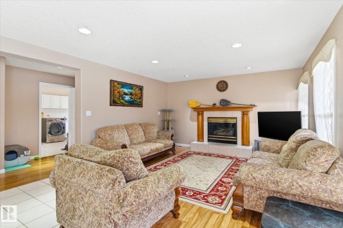 Living area featuring light-colored walls, recessed lighting, and a fireplace with a mantel - 128 Weaver Drive, Edmonton, AB - Indoor Photo Showing Living Room With Fireplace