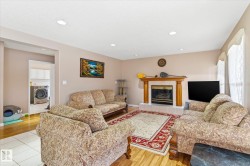 Living area featuring light-colored walls, recessed lighting, and a fireplace with a mantel - 