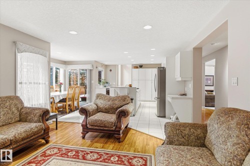 Living area featuring hardwood flooring, a decorative area rug, and recessed lighting - 128 Weaver Drive, Edmonton, AB - Indoor Photo Showing Living Room