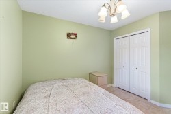 This room features light green walls, tiled flooring, and a ceiling-mounted light fixture - 