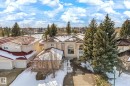 This property features a stucco exterior, a tiled roof, and a paved driveway - 128 Weaver Drive, Edmonton, AB  - Outdoor 