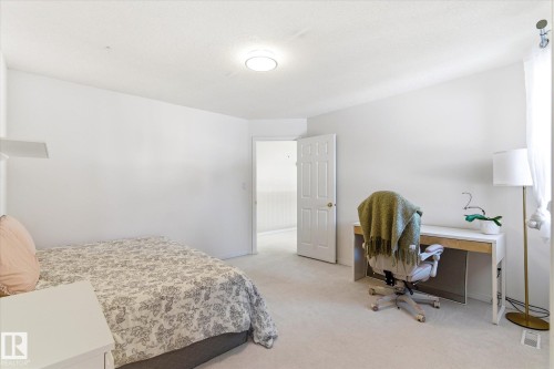 This room features light-colored carpeting, white walls, and a ceiling light fixture - 128 Weaver Drive, Edmonton, AB - Indoor Photo Showing Bedroom