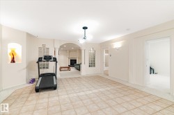 This versatile interior space features light-colored walls and a combination of tiled and carpeted flooring - 