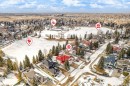 Aerial view showcasing the property situated within a developed neighborhood featuring snow-covered landscapes, mature trees, and a visible street - 128 Weaver Drive, Edmonton, AB  - Outdoor With View 