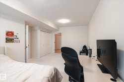 The property features white walls, light-colored carpeting, and a ceiling light fixture - 