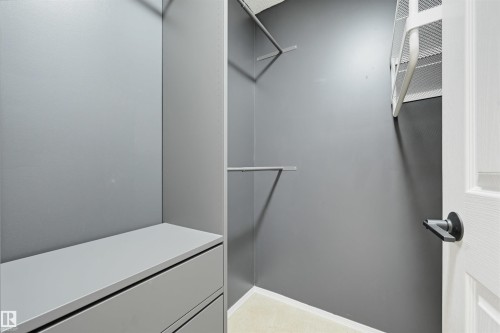 Walk-in closet with built-in shelving, hanging rods, and integrated drawers - 21 Escada Close, St. Albert, AB - Indoor