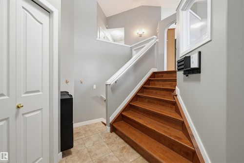 Staircase featuring wood-finish treads and white risers with a coordinating handrail - 21 Escada Close, St. Albert, AB - Indoor Photo Showing Other Room