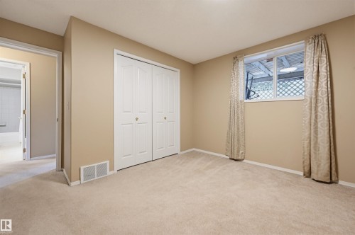 Room featuring neutral carpeting, light beige wall paint, and white trim - 21 Escada Close, St. Albert, AB - Indoor Photo Showing Other Room