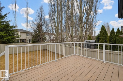 Spacious outdoor deck with composite decking and white metal railings, overlooking a fenced yard - 21 Escada Close, St. Albert, AB - Outdoor With Deck Patio Veranda