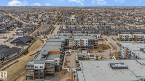 Contemporary multi-story building featuring balconies and a flat roofline - 202 7459 May Common, Edmonton, AB - Outdoor With View
