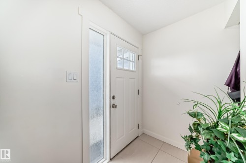 Entryway featuring a white paneled door with windowpanes and an opaque sidelight - 75 Amberly Court, Edmonton, AB - Indoor Photo Showing Other Room