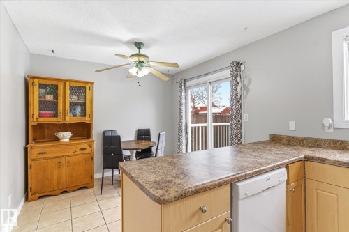 Kitchen area with a large island and light wood cabinetry - 70 Stirling Road, Edmonton, AB - Indoor Photo Showing Kitchen