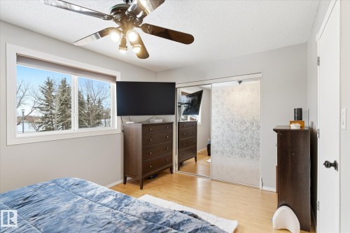 Bright interior space featuring wood-finish flooring and a ceiling fan with integrated lighting - 70 Stirling Road, Edmonton, AB - Indoor Photo Showing Bedroom