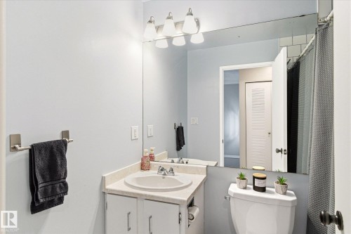 Bathroom vanity featuring a white undermount sink, a chrome faucet, and a light-colored countertop - 70 Stirling Road, Edmonton, AB - Indoor Photo Showing Bathroom