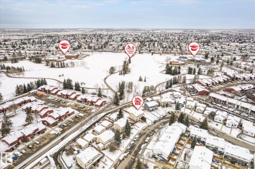 Aerial perspective showcasing a residential neighborhood with snow-covered rooftops and extensive green spaces - 70 Stirling Road, Edmonton, AB - Outdoor With View
