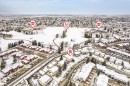 Aerial perspective showcasing a residential neighborhood with snow-covered rooftops and extensive green spaces - 70 Stirling Road, Edmonton, AB  - Outdoor With View 