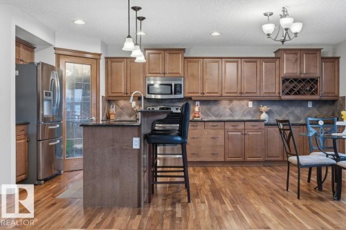 Kitchen featuring wood-finish flooring, recessed lighting, and a chandelier - 1613 Kerr Road, Edmonton, AB - Indoor Photo Showing Kitchen