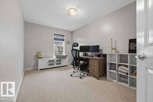 Neutral-toned room featuring a single window with blinds, light-colored carpeting, and a flush-mount ceiling light - 1613 Kerr Road, Edmonton, AB - Indoor Photo Showing Office