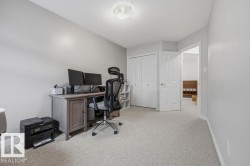 Versatile room featuring light grey wall paint and light-colored carpeting - 