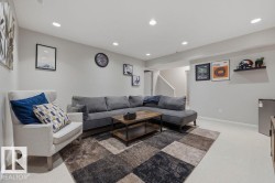 Downstairs Spacious living area featuring recessed lighting, light-toned carpeting, and a visible staircase - 