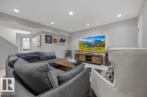 Downstairs Recreation room featuring recessed lighting and a media wall with built-in shelving - 1613 Kerr Road, Edmonton, AB - Indoor