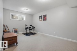 Bedroom in basement - used for music room_Carpeted room featuring a white window frame, light gray wall paint, and white baseboards - 