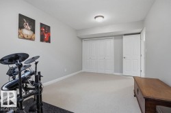 Basement ---Spacious room featuring neutral carpeting, light gray wall paint, and white trim - 