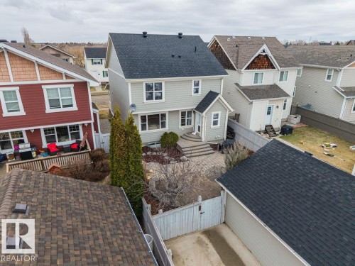 Rear exterior of a two-story home with light-colored siding and a dark shingle roof - 1613 Kerr Road, Edmonton, AB - Outdoor With Facade
