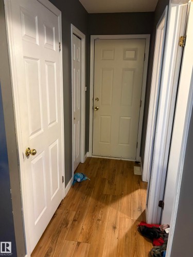 Hallway with wood-finish flooring and neutral-toned walls - 5306 44 Street, Cold Lake, AB - Indoor Photo Showing Other Room