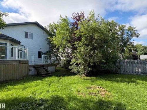 Deck with glass panel railing and steps to the yard - 5306 44 Street, Cold Lake, AB - Outdoor With Deck Patio Veranda