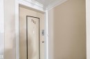 The property entrance features a door with a number 111, a peephole, and a door handle - 111 10225 117 Street, Edmonton, AB 