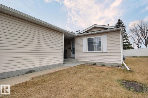 Front exterior with light-colored horizontal siding and a concrete walkway - 8146 27 Avenue, Edmonton, AB - Outdoor