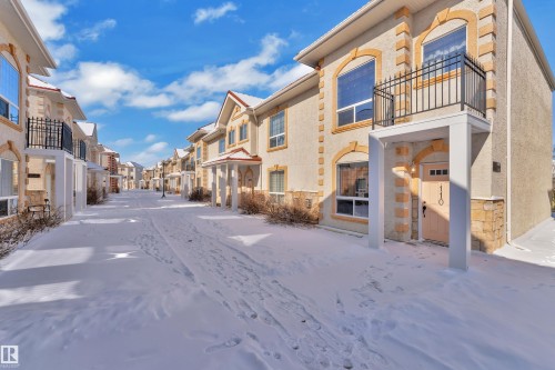Stucco exterior with stone accents and arched window details - 110 13825 155, Edmonton, AB - Outdoor