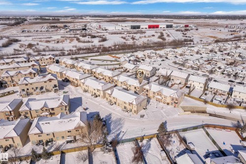 Aerial perspective of a multi-unit residential community featuring uniform architectural styles and pitched roofs - 110 13825 155, Edmonton, AB - Outdoor With View