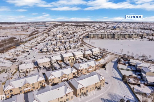 Suburban community featuring townhouse residences, detached homes, and apartment buildings - 110 13825 155, Edmonton, AB - Outdoor With View