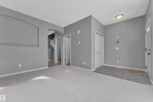 Open-concept interior featuring light gray walls and white trim - 110 13825 155, Edmonton, AB - Indoor Photo Showing Other Room