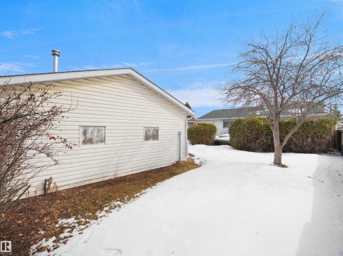 Side exterior of a white vinyl-sided structure with a pitched roof - 11044 166 Avenue, Edmonton, AB - Outdoor