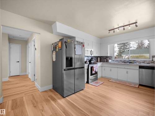 Kitchen featuring wood-finish flooring and white cabinetry - 11044 166 Avenue, Edmonton, AB - Indoor Photo Showing Kitchen