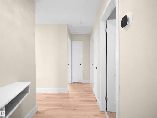 Hallway featuring light wood-finish flooring, white baseboards, and neutral wall tones - 11044 166 Avenue, Edmonton, AB - Indoor Photo Showing Other Room
