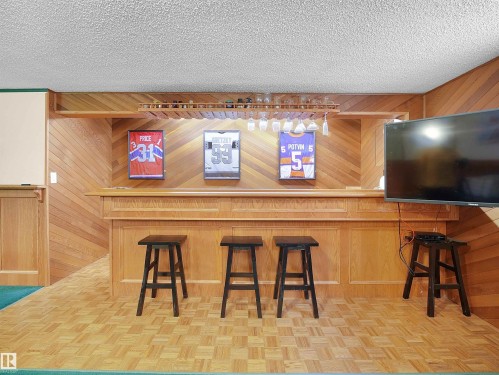 Built-in wood bar featuring panel detailing and a glass rack - 11044 166 Avenue, Edmonton, AB - Indoor Photo Showing Other Room