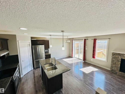 1655 Hammond Crescent, Edmonton, AB - Indoor Photo Showing Kitchen With Fireplace With Double Sink