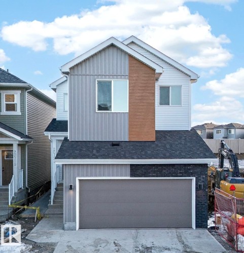 Contemporary two-story residence featuring a multi-textured facade with vertical siding, horizontal siding, and wood-finish accents - 20723 24 Avenue, Edmonton, AB - Outdoor With Exterior
