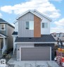 Contemporary two-story residence featuring a multi-textured facade with vertical siding, horizontal siding, and wood-finish accents - 20723 24 Avenue, Edmonton, AB  - Outdoor With Exterior 