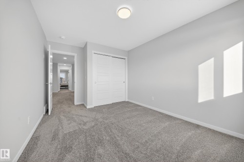 Neutral toned room with gray plush carpet and white baseboards - 20723 24 Avenue, Edmonton, AB - Indoor Photo Showing Other Room