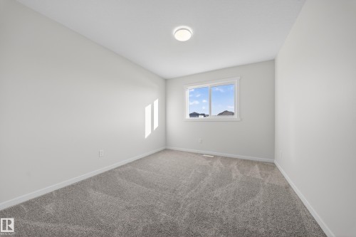 Room featuring neutral wall finishes and grey patterned carpet - 20723 24 Avenue, Edmonton, AB - Indoor Photo Showing Other Room
